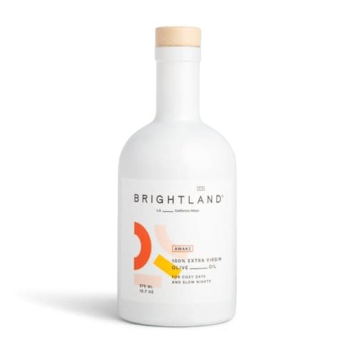 A white ceramic-coated bottle of Brightland Awake California extra virgin olive oil.