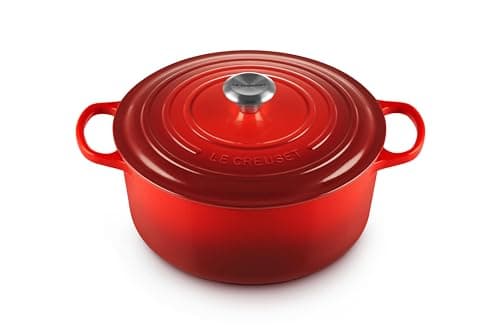 Le Creuset Signature 7-quart round Dutch oven in cerise, cream interior, brass knob.