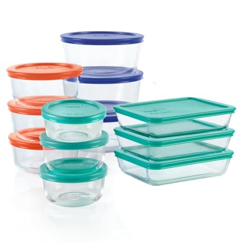 A set of clear Pyrex glass storage containers in three sizes with colored plastic lids.